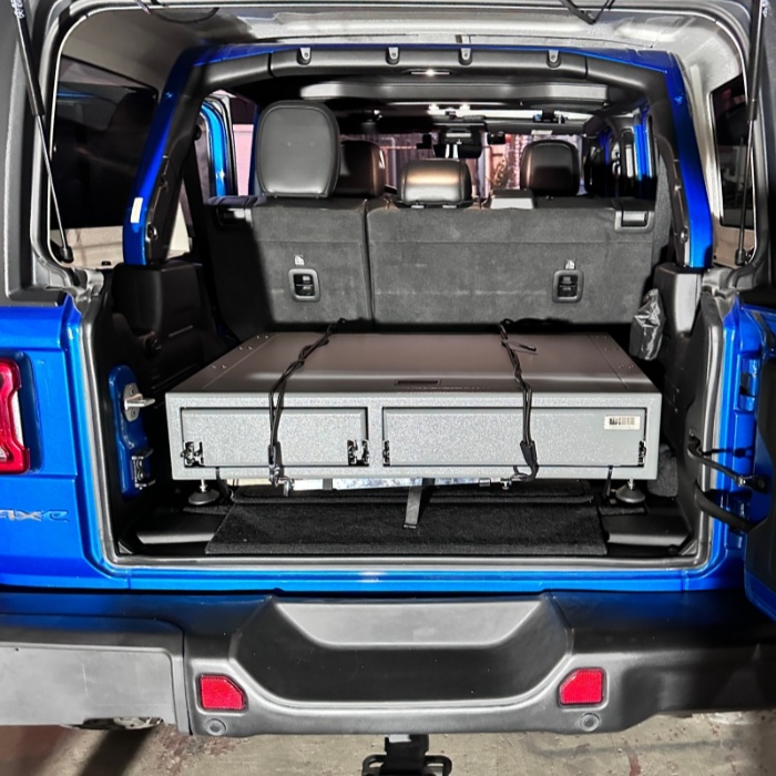 Jeep Wrangler with Metal Camper Box in Car